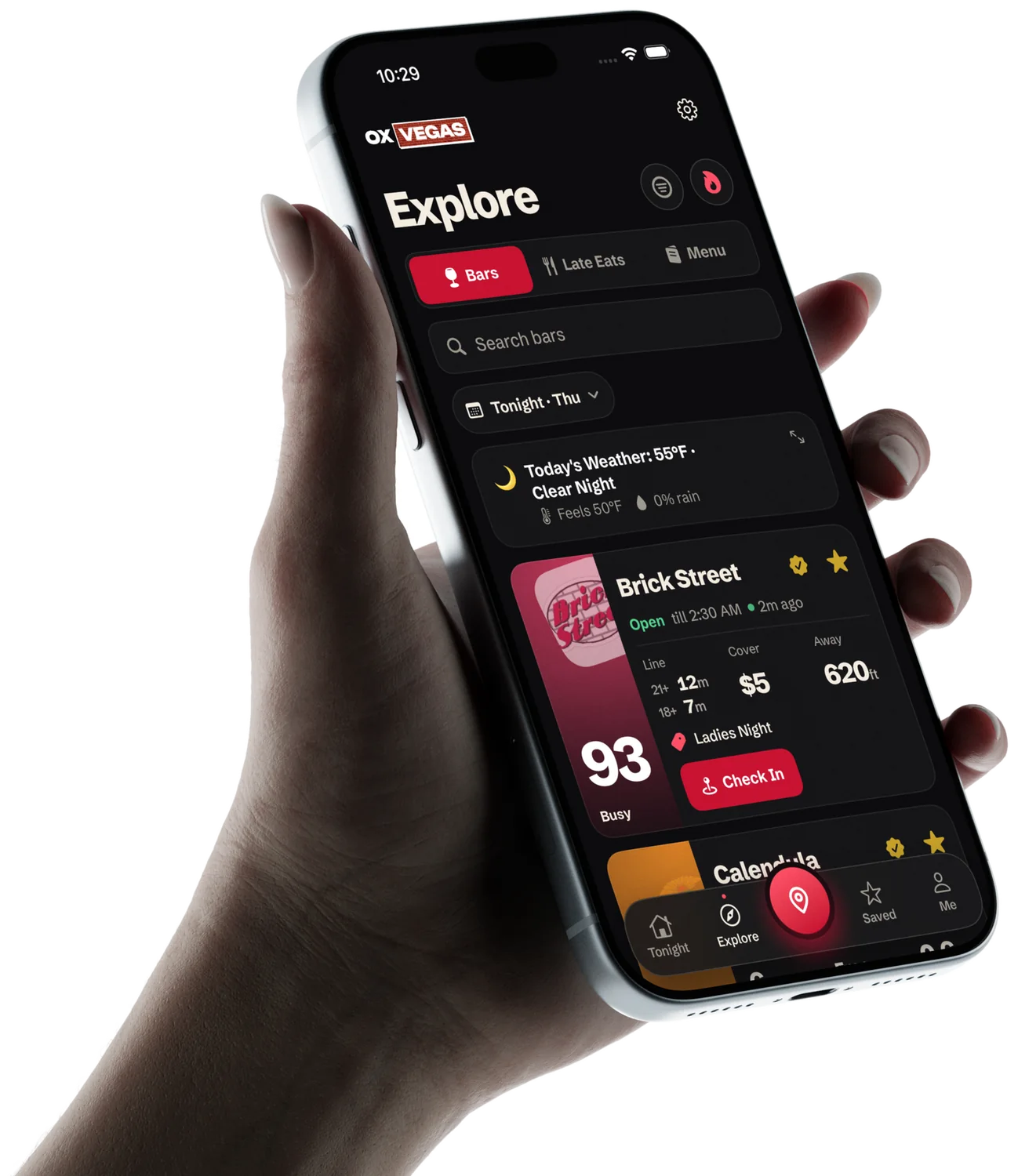 A hand holding a phone showing the oxvegas Explore tab with live line, cover and distance for Brick Street.